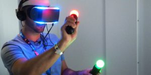 Man using Playstation VR headset and move controllers image description