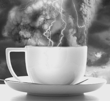 storm in a teacup white cup and plate with spoon on lightening and stormy background