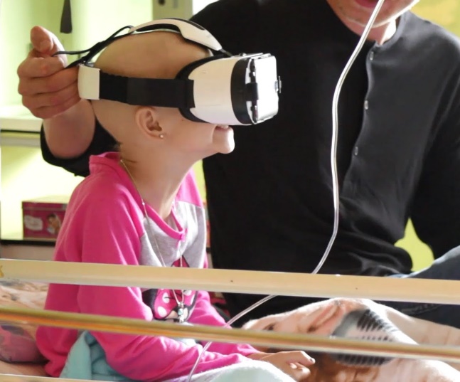 Young Girl in Hospital Bed with VR Goggles