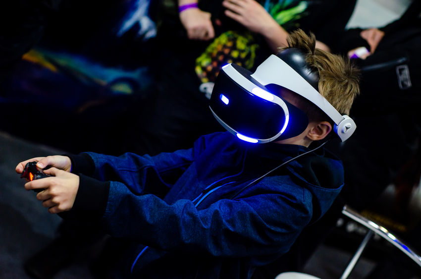 Kid in PS VR Headset playing a game