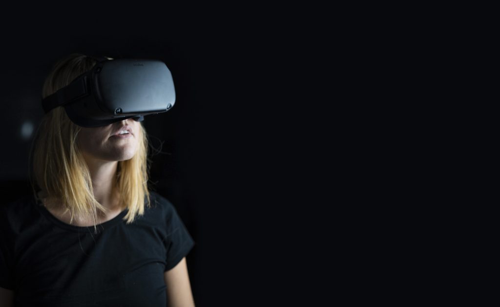 blonde woman wearing black oculus quest 2 headset