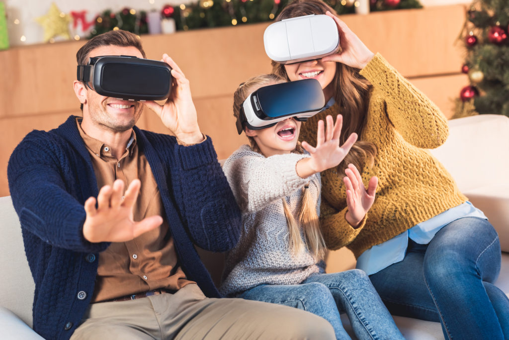 father, mother, and daughter using vr headsets
