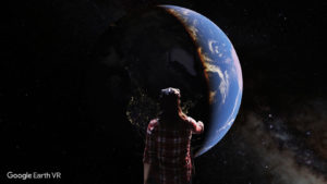 person wearing vr glasses facing planet earth in vr