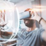 concept of digital screen,connection and interfaces.beraded hipster enjoyingvirtual reality glasses in modern design home studio.smartphone use with vr goggles headset.horizontal,flare,blurred.