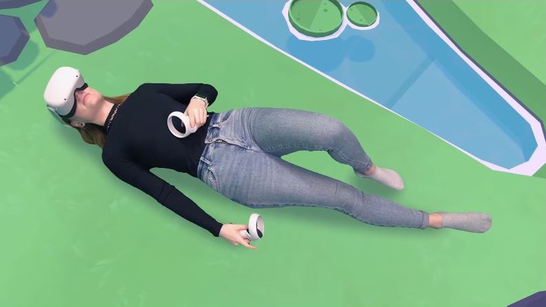 player wearing oculus headset and lying on vr grass in Garden of the Sea game