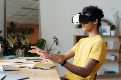 man in yellow t-shirt using vr headset in online class
