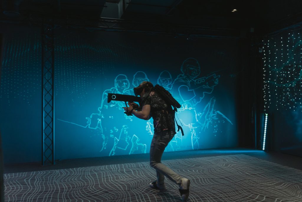 man playing with virtual reality gun