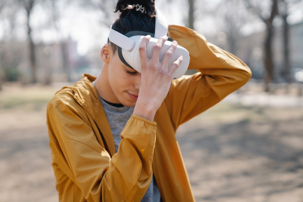 man removing vr headset from face