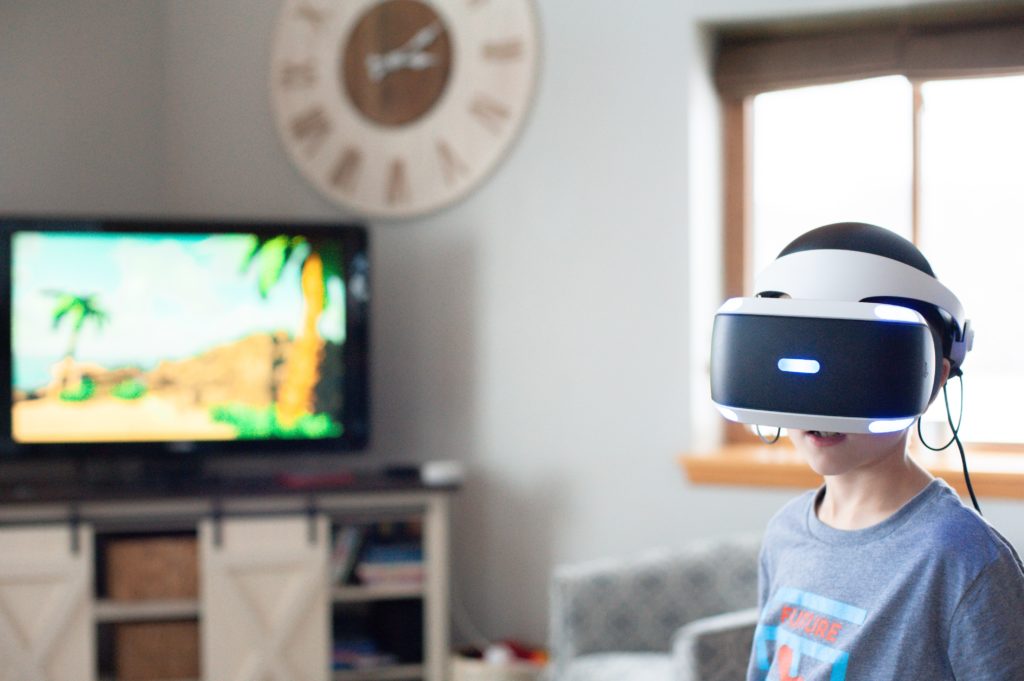 boy wearing vr headset while television is open