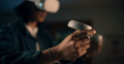 person wearing oculus quest headset and holding controllers