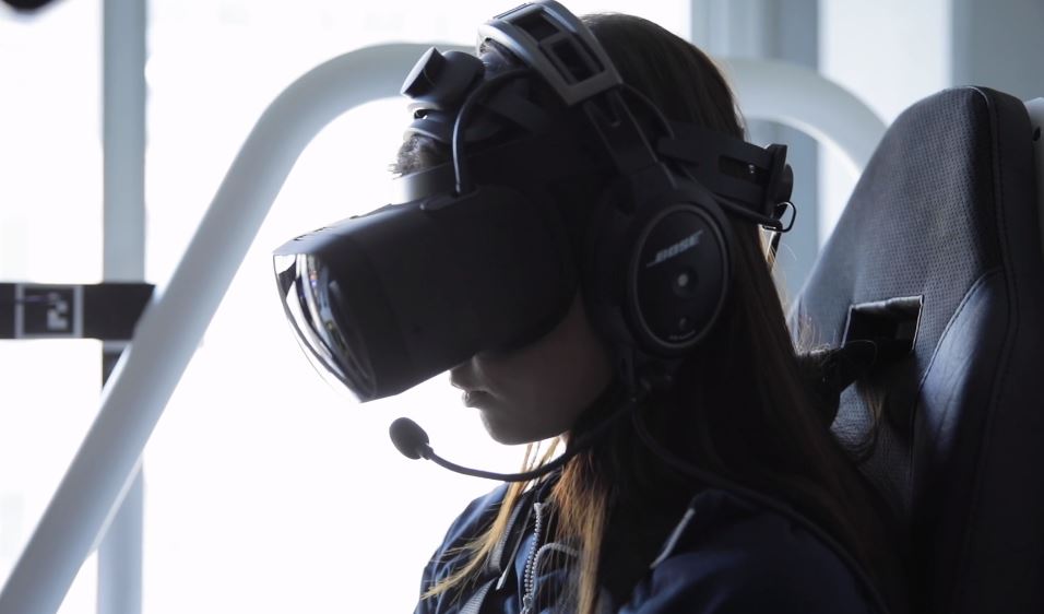 woman wearing varjo aero vr headset in a demo chair