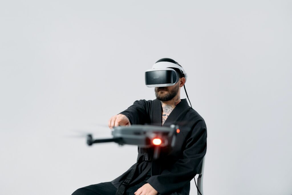 man wearing vr headset and pointing at a drone