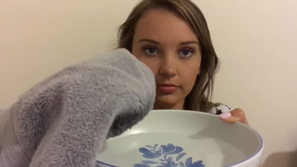 asmr darling woman dipping a towel to warm water in the bowl
