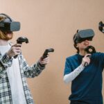 man and woman playing vr game with vr headset and controllers