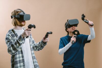 man and woman playing vr game with vr headset and controllers