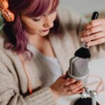 woman recording asmr using makeup brush