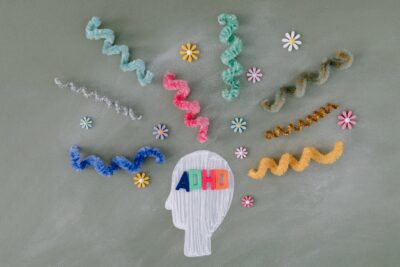 adhd text inside a head chalk drawing with spiral cords outside