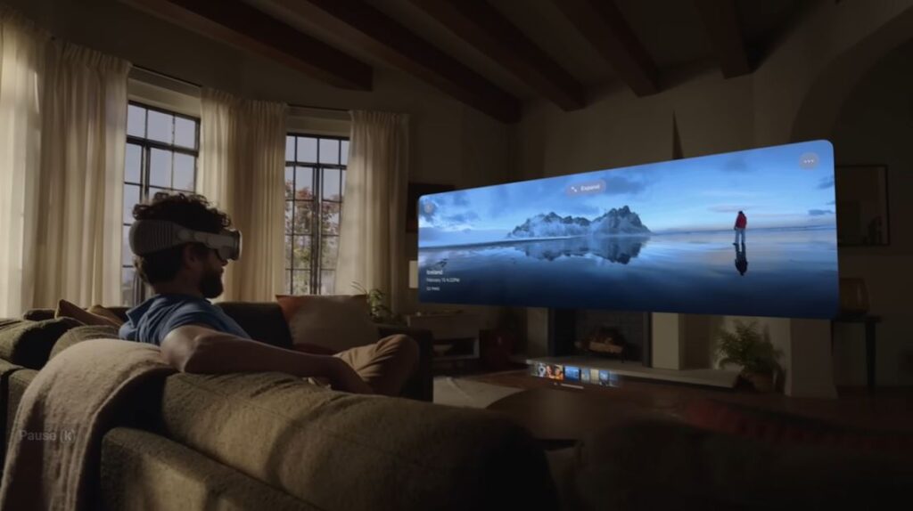 man in the living room watching via apple vision pro vr headset