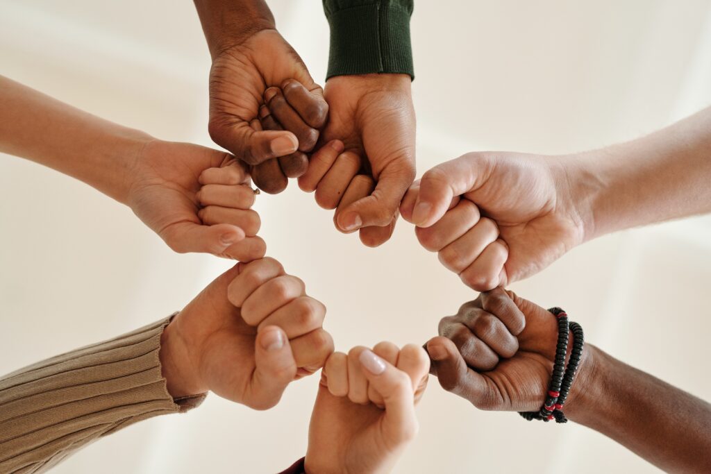 teens doing fist bump as a group