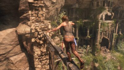 lara croft crossing a thin wood bridge in tomb raider game