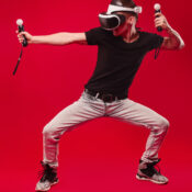 man with virtual reality glasses showing gesture isolated on a red background Full-Body Tracking in VR
