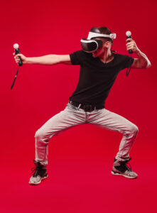 man with virtual reality glasses showing gesture isolated on a red background Full-Body Tracking in VR