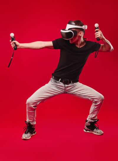 man with virtual reality glasses showing gesture isolated on a red background Full-Body Tracking in VR